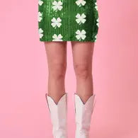 A bright green sequin mini skirt with white colors.