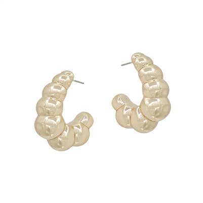 A pair of gold hoops which feature a pearl-like texture. 
