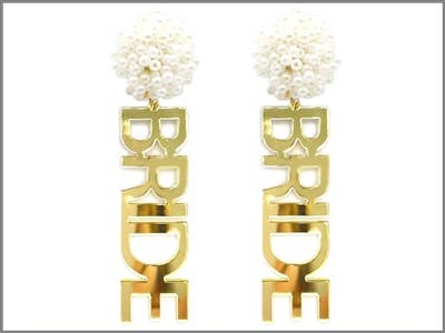 A pair of gold dangling earrings that read "bride" and have pearl detailing. 