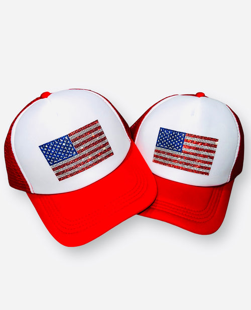 A white and red baseball cap with a rhinestone American flag on the front.