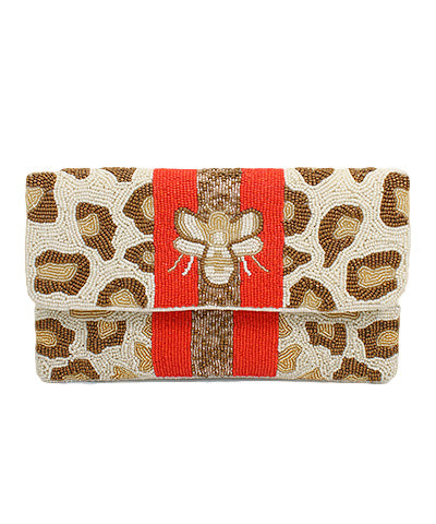 A small beaded clutch in a cheetah print with a red stripe down the middle and a bumble bee on the top flap.
