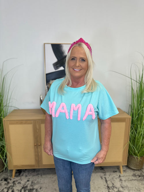 A blue, oversized t-shirt with the word “mama” in raised pink letters.