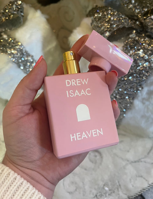 The Drew Isaac Heaven fragrance which features a light pink bottle.
