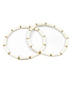 A pair of white bracelets with chunky beading.