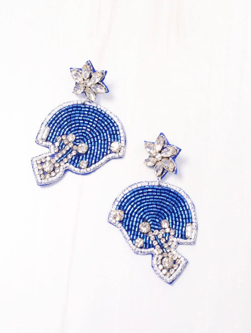 A large pair of beaded earrings in the shape of a blue and silver football helmet.