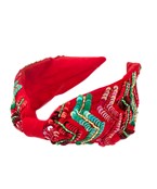 A bright red wide headband with multicolored sequins in a chevron print. 