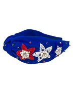 A royal blue wide headband with red and white beaded floral patches.