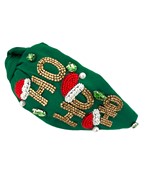 A Christmas themed headband featuring an emerald green fabric and "HO HO HO" text along the sides in gold rhinestones and a Santa hat on top.
