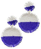 A pair of large blue and white beaded earrings in a circle shape.
