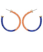 A pair of orange and royal blue sparkle hoops.