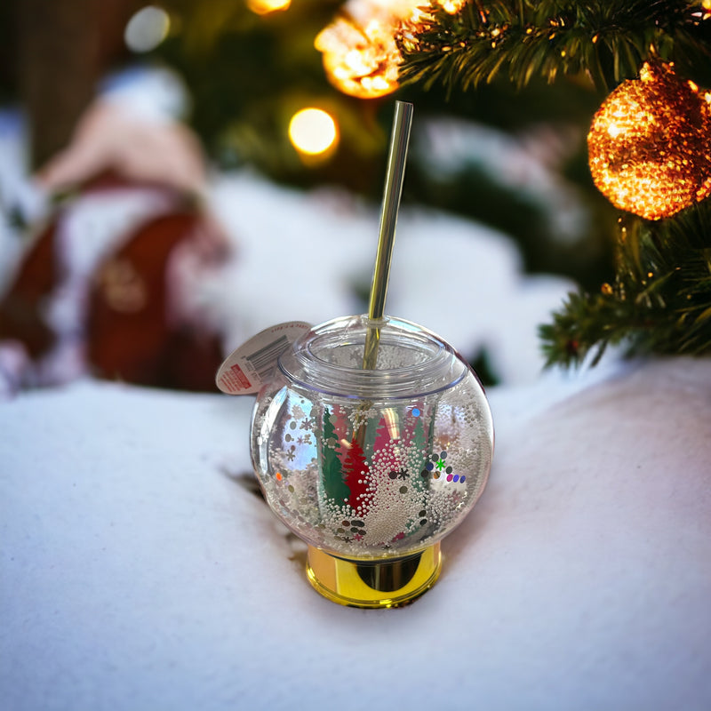 A cup in the shape of a snow globe and includes a straw.
