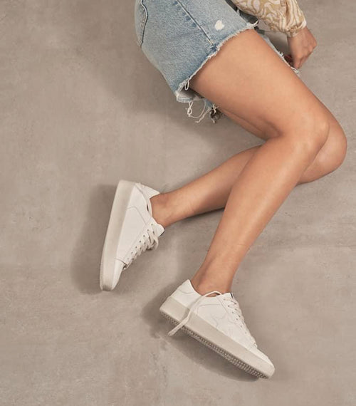 White leather sneakers with a platform sole and star stitch detailing.