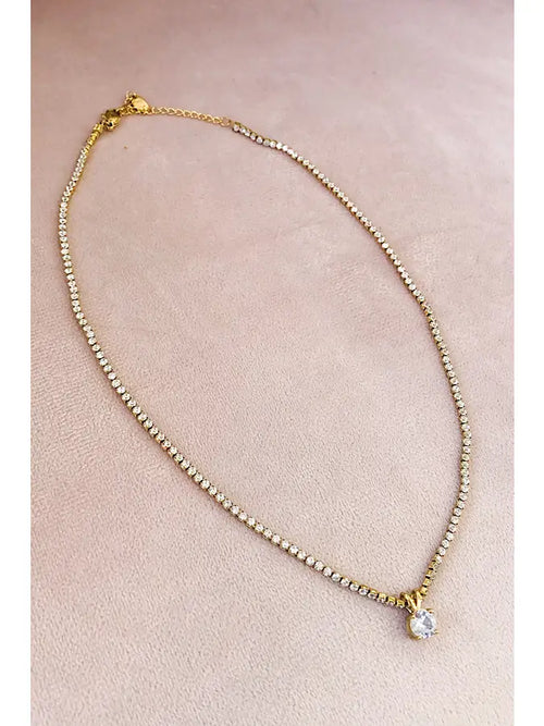 A medium length gold necklace with rhinestones on the chain and as a pendant. 