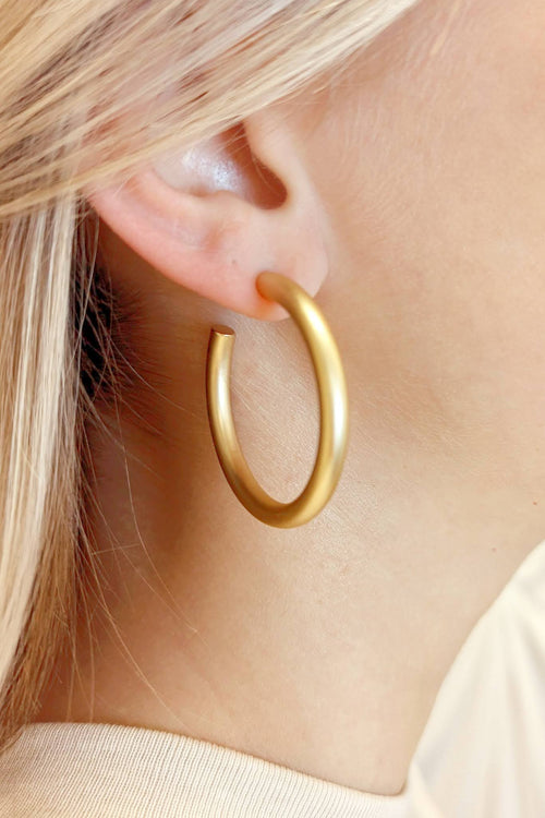 A pair of simple gold hoops in a medium size.