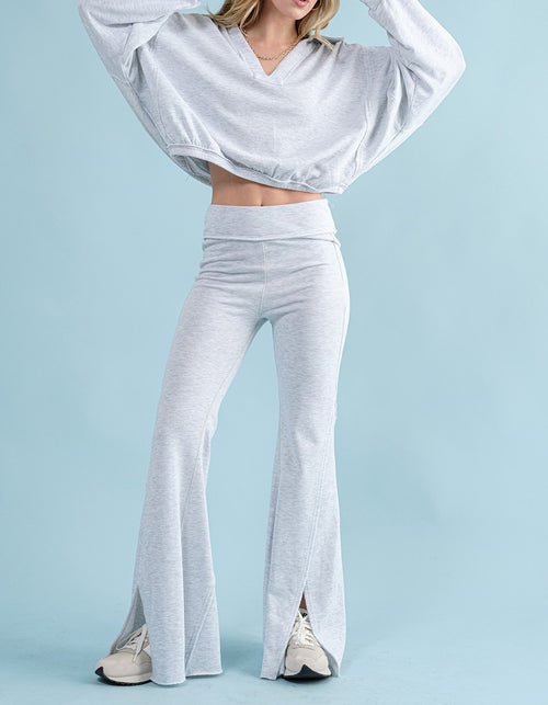 A pair of light grey heathered yoga pants with wide legs and a center split hem.