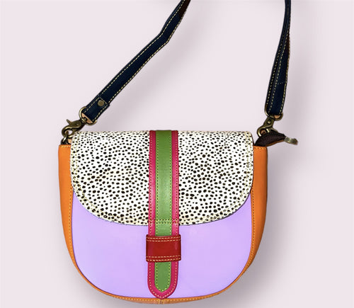 A bright purple, orange, and animal print crossbody purse with a red and green clasp.