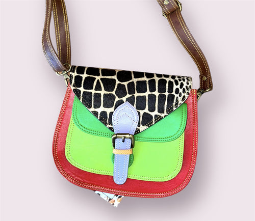 A red, green, and animal print purse with a light blue clasp. 