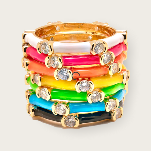 A set of multicolored, stackable rings including gold and diamond detailing.