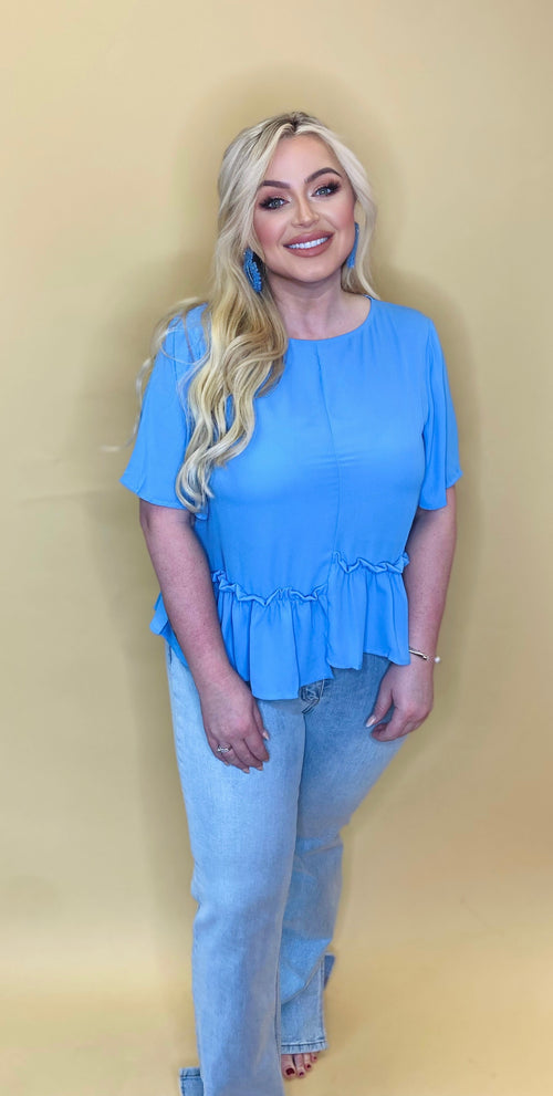 Sky blue t-shirt blouse with a ruffle bottom hem and scoop neck.