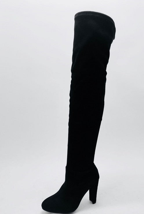 A pair of over-the-knee black suede heeled boots. 