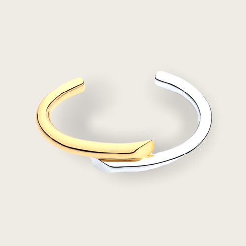 A half silver and half gold bangle bracelet.