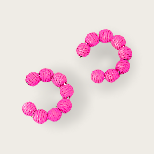 A pair of hot pink deaded hoops.