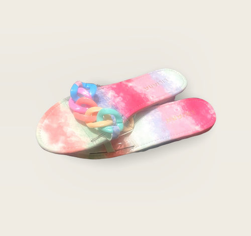 A pair of flat sandals in a pastel tye-dye print and chunky chain strap.