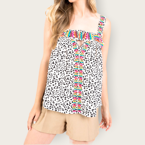 A black and white cheetah sleeveless blouse with embroidery multi-colored striped around the front, straps, and chest.