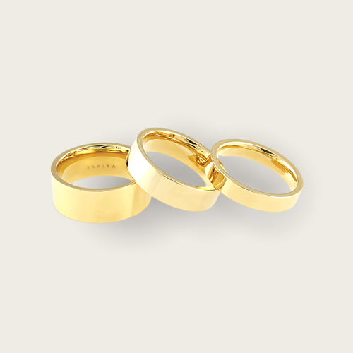 A set of 3 gold rings that vary in width.