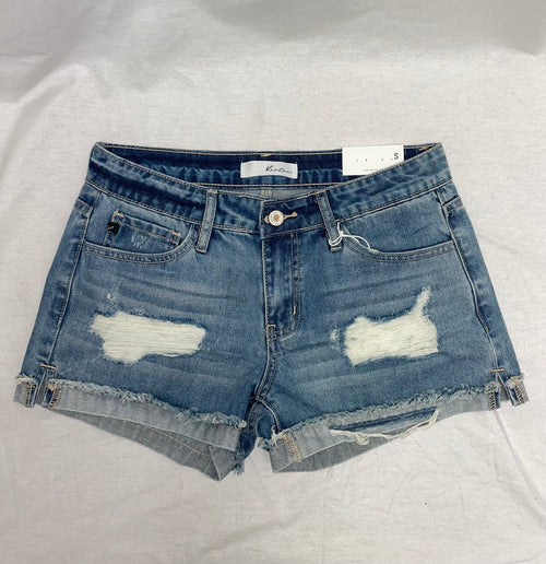 A pair of mid-rise denim shorts that feature two rips and a distressed cuff.