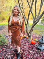 A rust colored velvet wrap dress featuring tassel sleeves and bottom hem. 