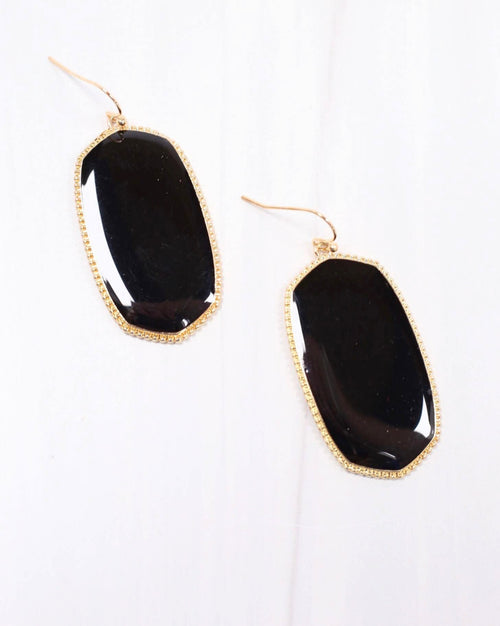A pair of black stone earrings with gold detailing. 