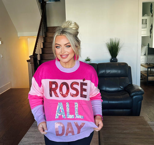 A pink and purple bulky-striped crewneck with "Rose All Day" on the front in sequins.