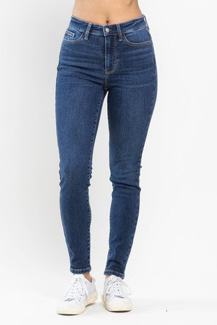 A pair of dark wash skinny jeans with a mid-rise waist.
