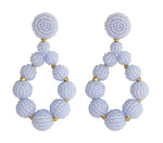 A pair of sky blue and gold chunky beaded earrings in a hollow teardrop shape.