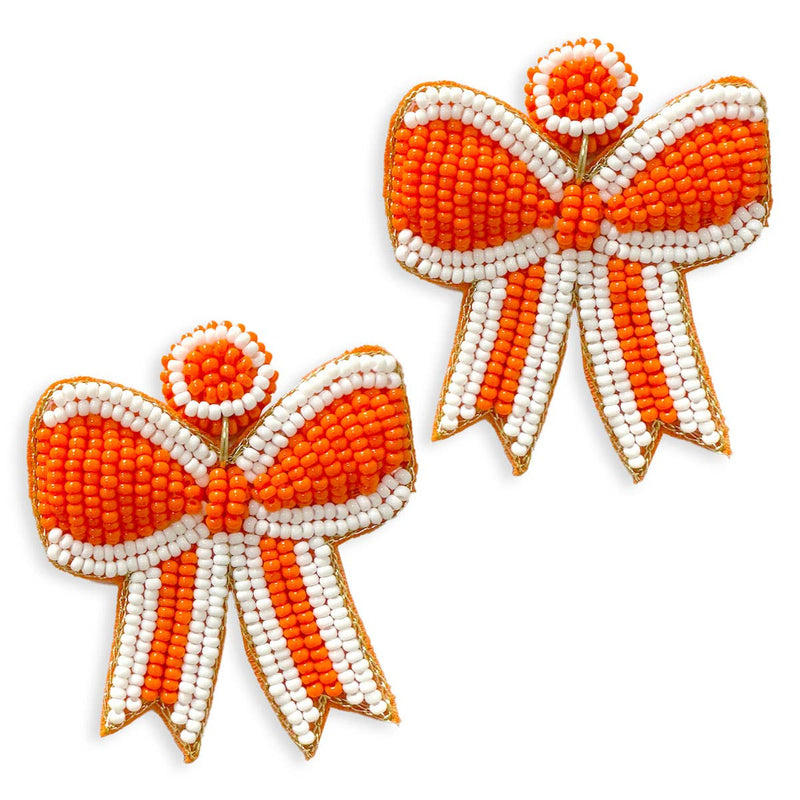 A pair of bright orange beaded earrings in the shape of bows.