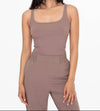 A dark nude tank top in a cotton ribbed fabric and square neck.