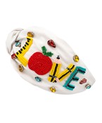 A white wide headband with school themed patches in the word "Love".