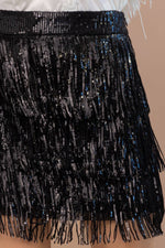A black sequin layered fringe mini skirt featuring a high waist.