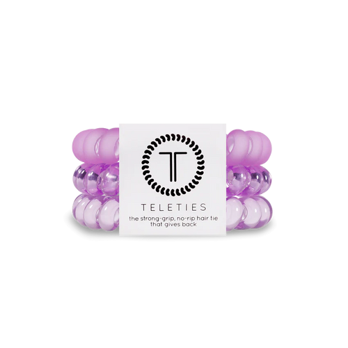 A pack of 3 springy, no-pull, rubber hair ties in the colors bright purple and light purple.