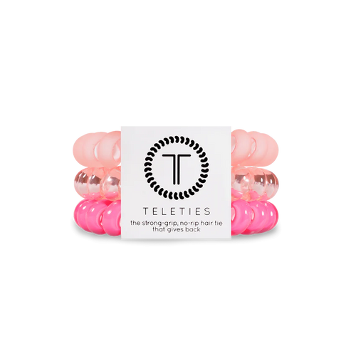 A pack of 3 springy, no-pull, rubber hair ties in the colors light pink and hot pink.