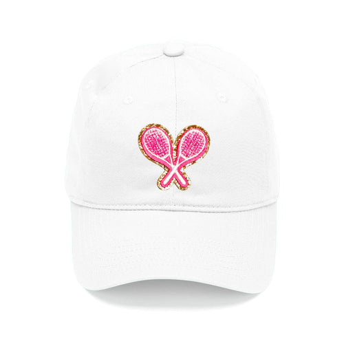 A white baseball cap with a hot pink glitter tennis rackets patch in the center.