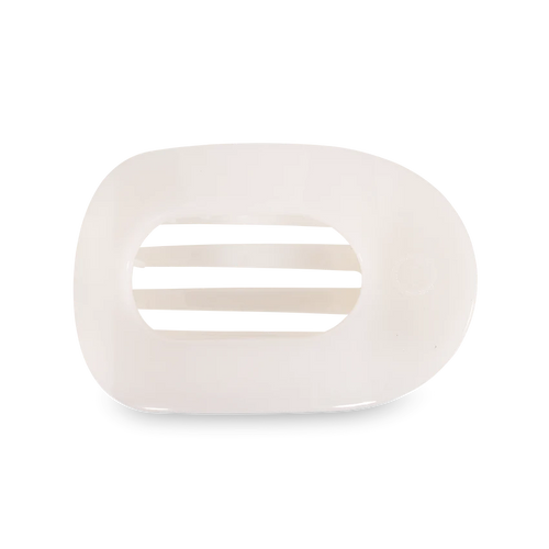 A flat round hair clip in a soft white color.