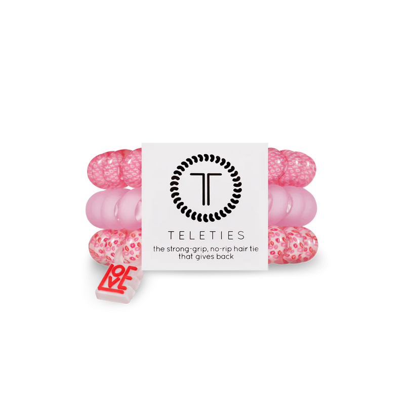 A pack of 3 springy, no-pull, rubber hair ties in the colors bright pink and pink print.
