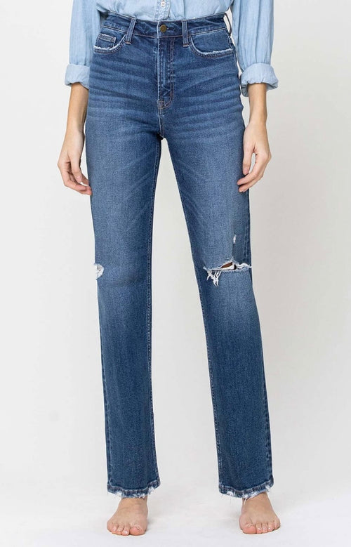 A pair of boot cut high waisted jeans with minimal distressed holes.