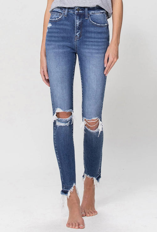 A pair of distressed, dark-wash skinny jeans with a high waist and frayed rem.