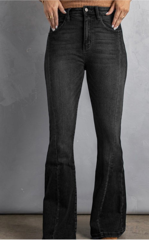 A pair of black flare jeans with a high waist and pockets.