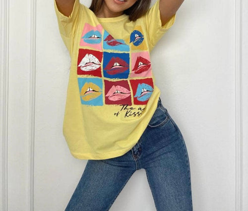 A bright yellow graphic t-shirt with color blocking and lips.