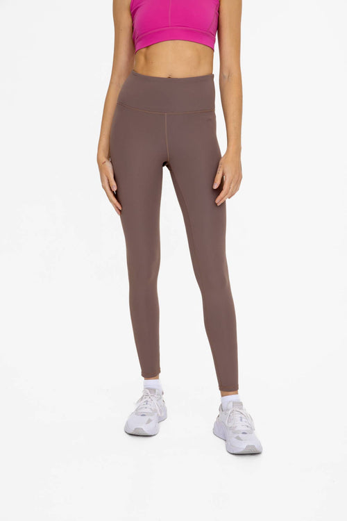 A pair of brown textured leggings with a high waist.